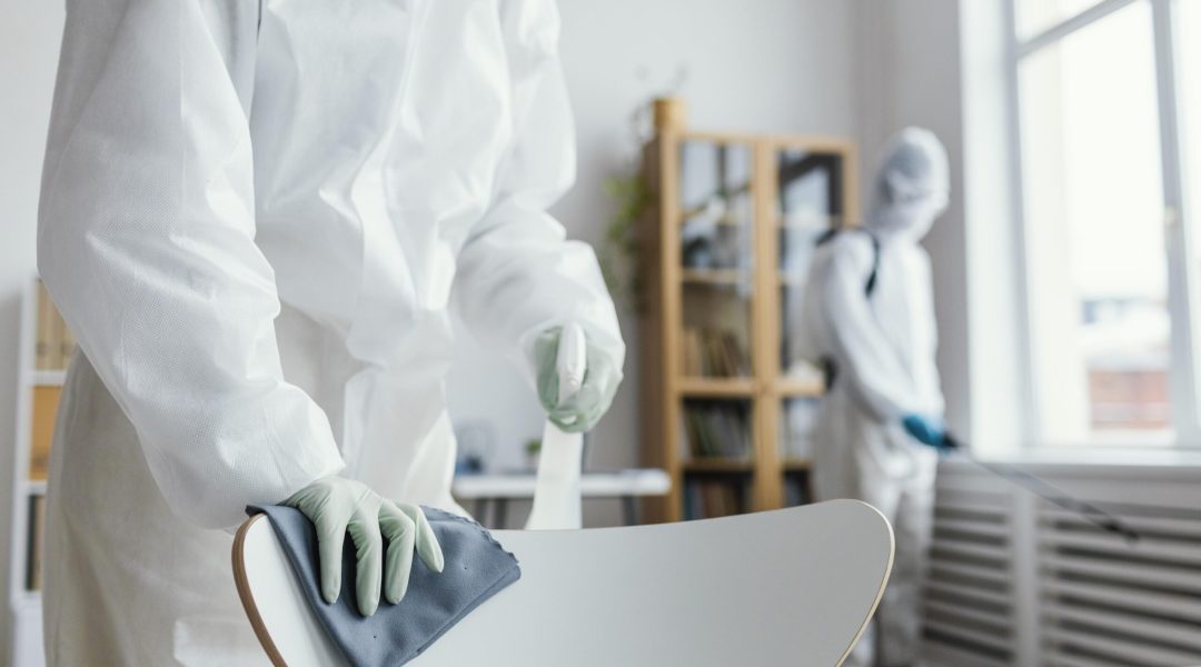 people-disinfecting-biohazard-area